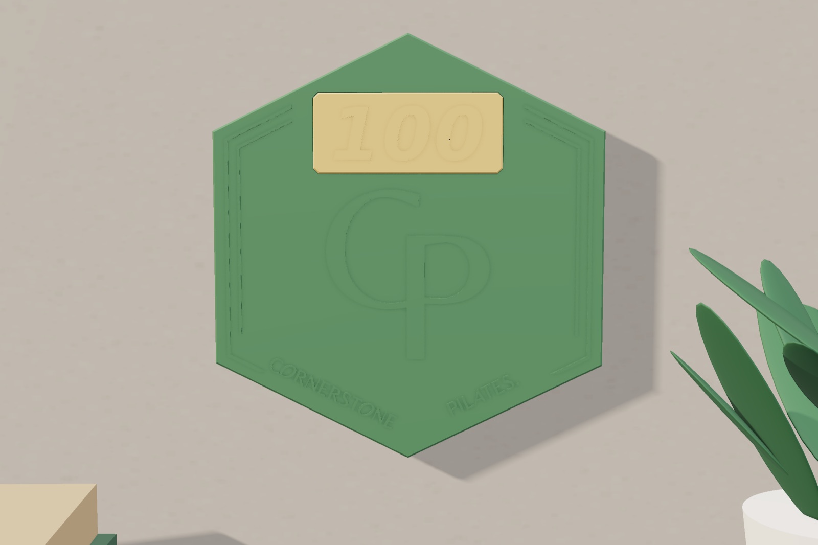 Render: the plaque with a 100 tile hanging on a wall beside a plant